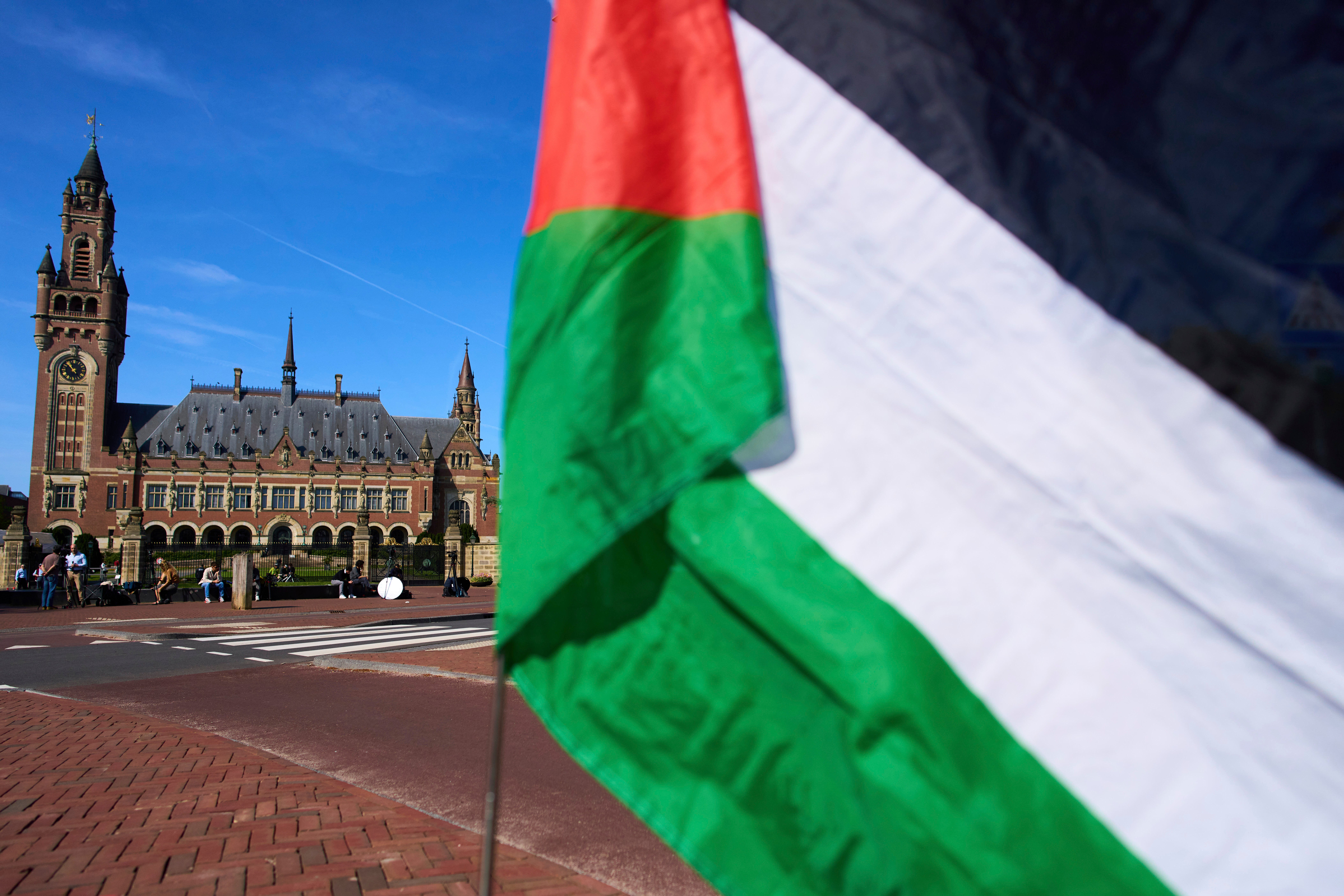 A Palestinian flag flies outside the International Court of Justice, which opened hearings into a United Nations request for an advisory opinion on Israel's obligations to allow humanitarian assistance in Gaza and the West Bank, in The Hague, Netherlands, on April 28, 2025.
