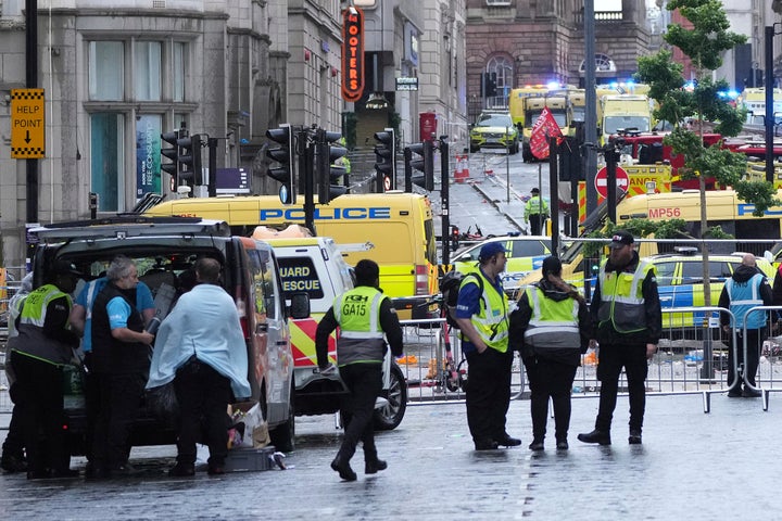Police and emergency personnel deal with an incident near the Liver Building during the Premier League winners parade in Liverpool, England, Monday, May 26, 2025.
