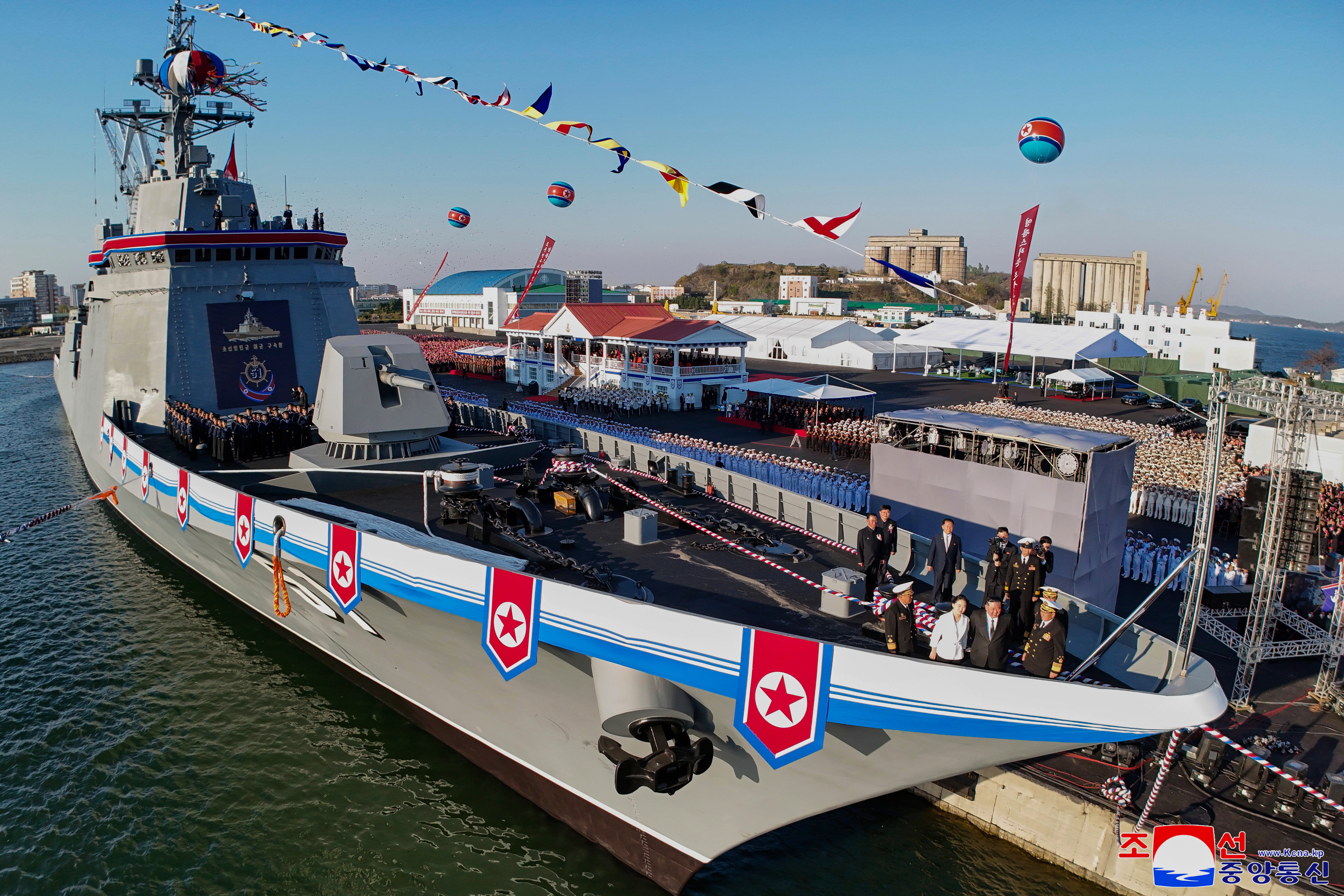 North Korean dictator Kim Jong Un, second right, and his daughter, third right, seen at bottom right, attend a ceremony to unveil a new naval destroyer at a western port in Nampo.