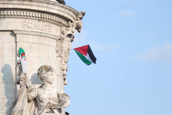 Protesters raise Palestinian flags at Place de la Republique in Paris, on June 9, calling for the release of the passengers of the sailing boat Madleen, intercepted in international waters by the Israeli army.