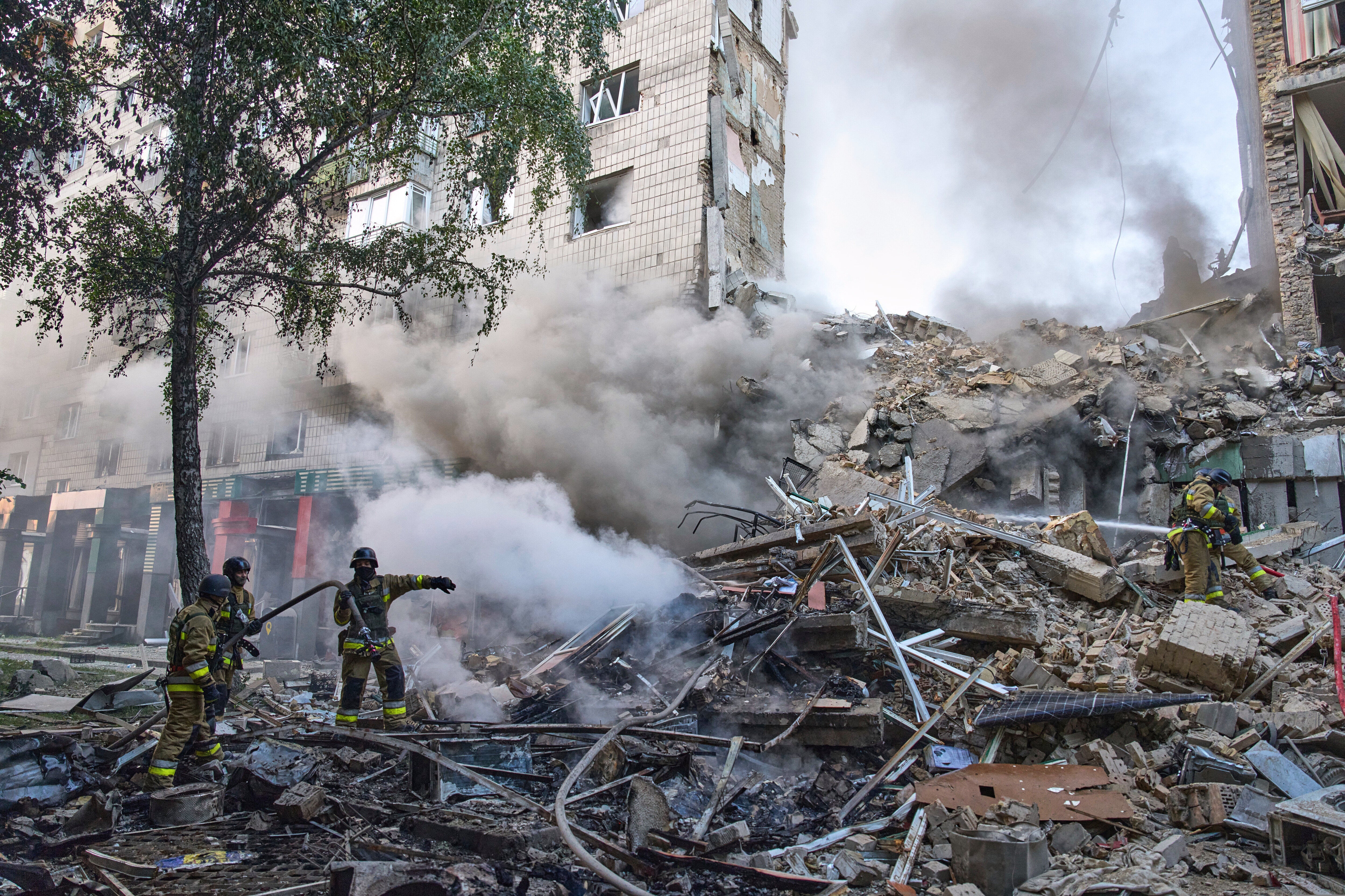 Firefighters put out the fire after a Russian missile hit a residential building during Russia's massive missile and drone air attack in Kyiv, Ukraine, Tuesday, June 17, 2025. (AP Photo/Efrem Lukatsky)