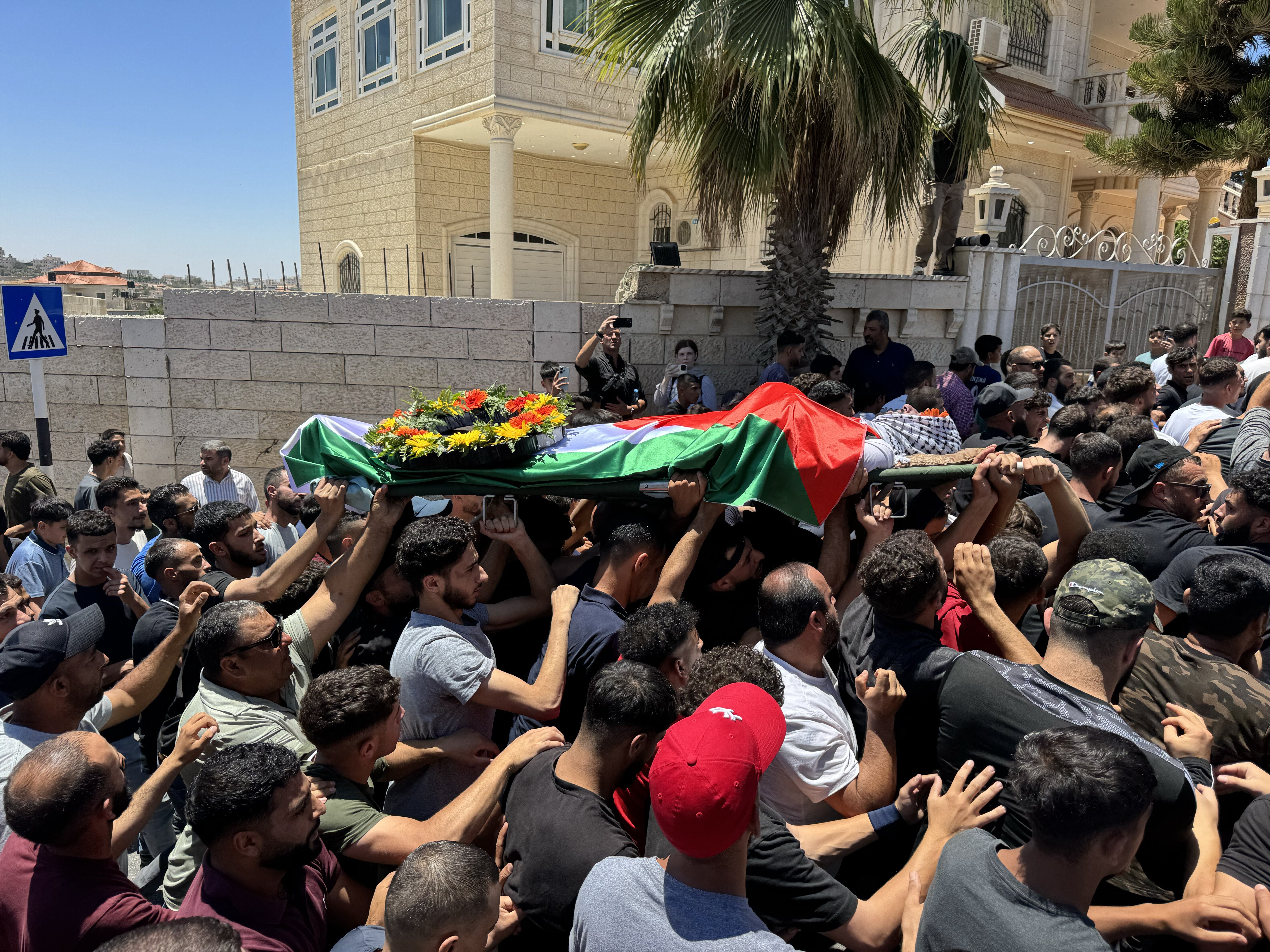 On Sunday, a large group of people attend the funeral of Sayfollah Musallet and Hussein Al-Shalabi, who were killed by Israeli settlers in the West Bank on Friday.