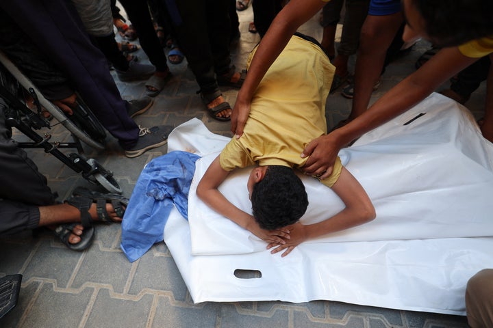A Palestinian boy bids farewell to his cousin Saraj Ibrahim, who was killed in an Israeli strike that hit Nuseirat in the central Gaza Strip on July 13, 2025.