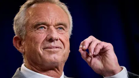 Getty Images Close-up of the face of Robert F Kennedy Jr, who stares into the middle-distance with a curled hand close to his face
