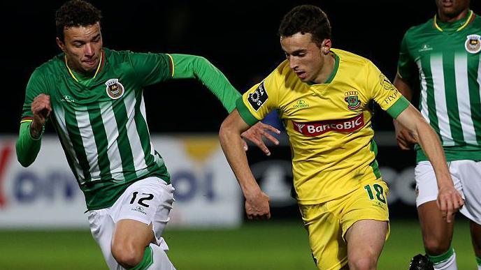 Diogo Jota running with the ball in yellow Pacos de Ferreira kit