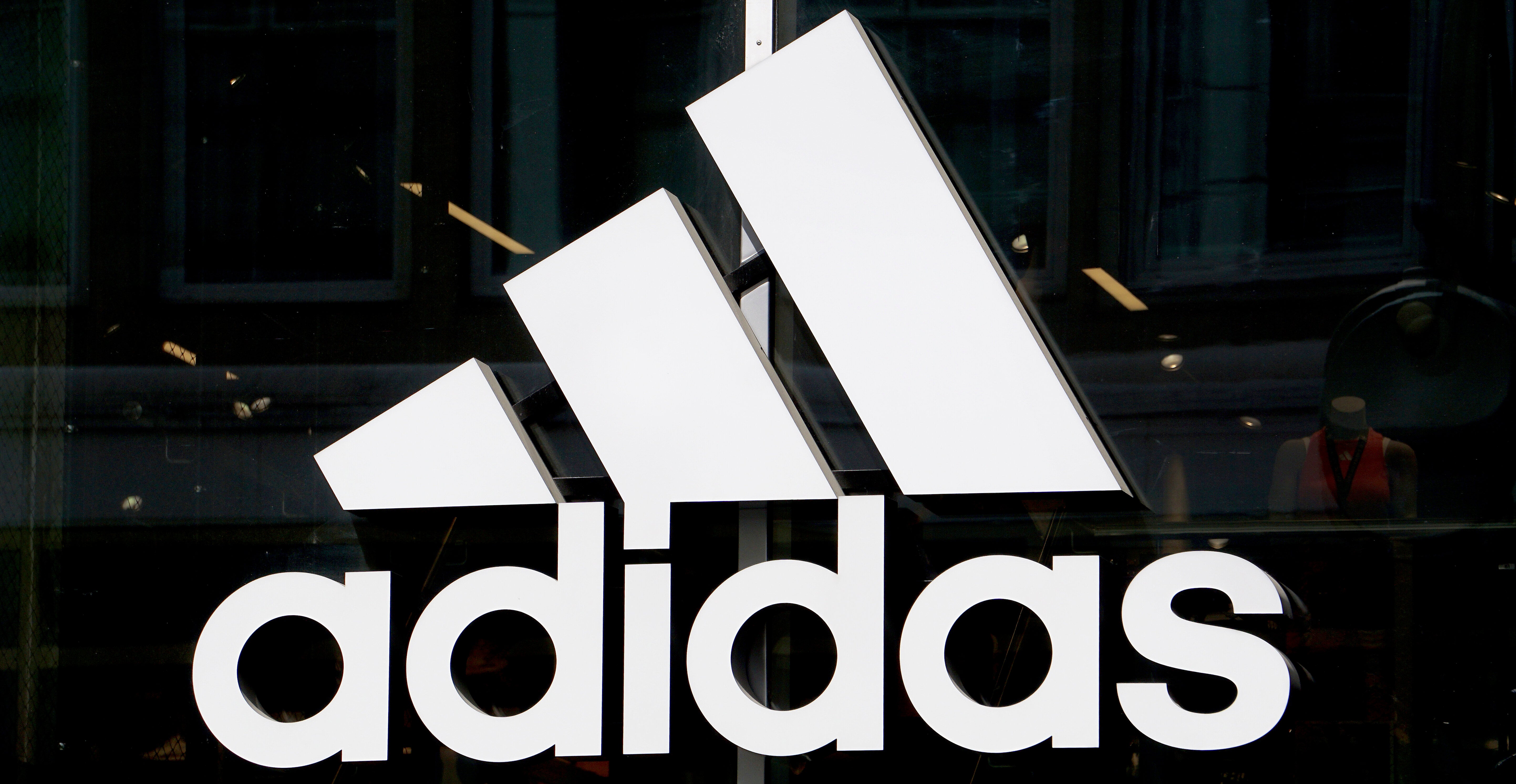 This May 6, 2019 photo shows the logo of the sports goods manufacturer Adidas in Berlin, Germany. (AP Photo/Michael Sohn)