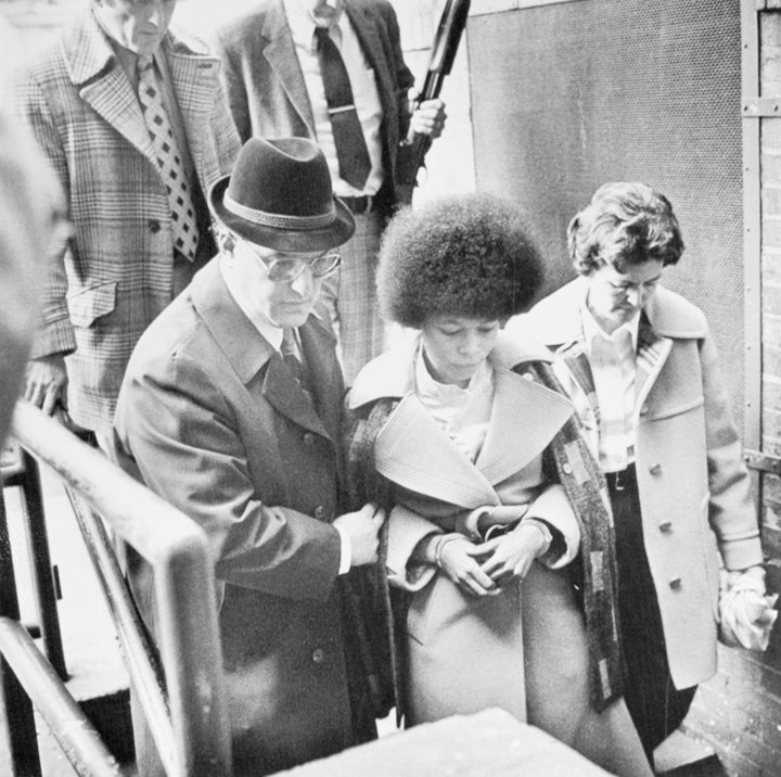 Assata Shakur leaves Middlesex County court April 25, escorted by County Sheriff Joseph DeMarino (light coat) after she was sentenced to 26 to 33 years on various assault, weapons and robbery charges in connection with the 1973 murder of a New Jersey State trooper.