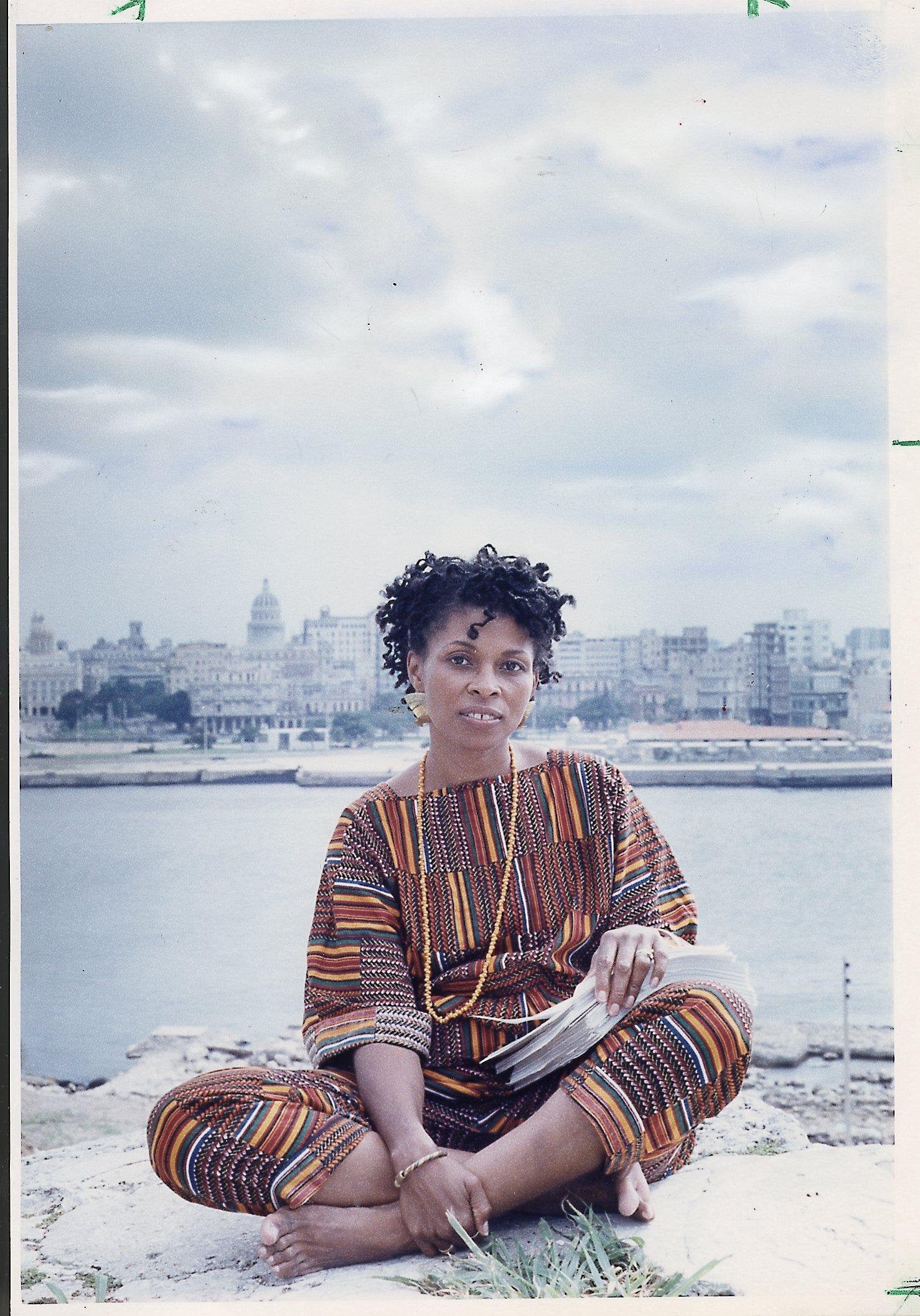 Joanne Deborah Chesimard, aka Assata Shakur, holding the manuscript of her autobiography with Old Havana, Cuba, in the background on October 7, 1987. (Photo by Ozier Muhammad/Newsday RM via Getty Images)