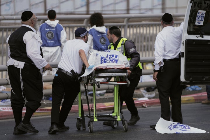 Israeli Zaka rescue and recovery team carry the body of a victim at the scene of shooting attack carried out by two Palestinian gunmen, in which several people were killed and others injured at a bus stop in Jerusalem, on Sept. 8, 2025.