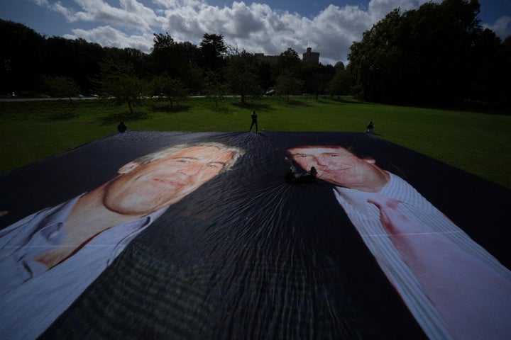 Activist from the protest group Everyone Hates Elon put up a poster of President Donald Trump and Jeffrey Epstein, ahead of the state visit by U.S. President Donald Trump, in Windsor, England, Monday, Sept. 15, 2025.