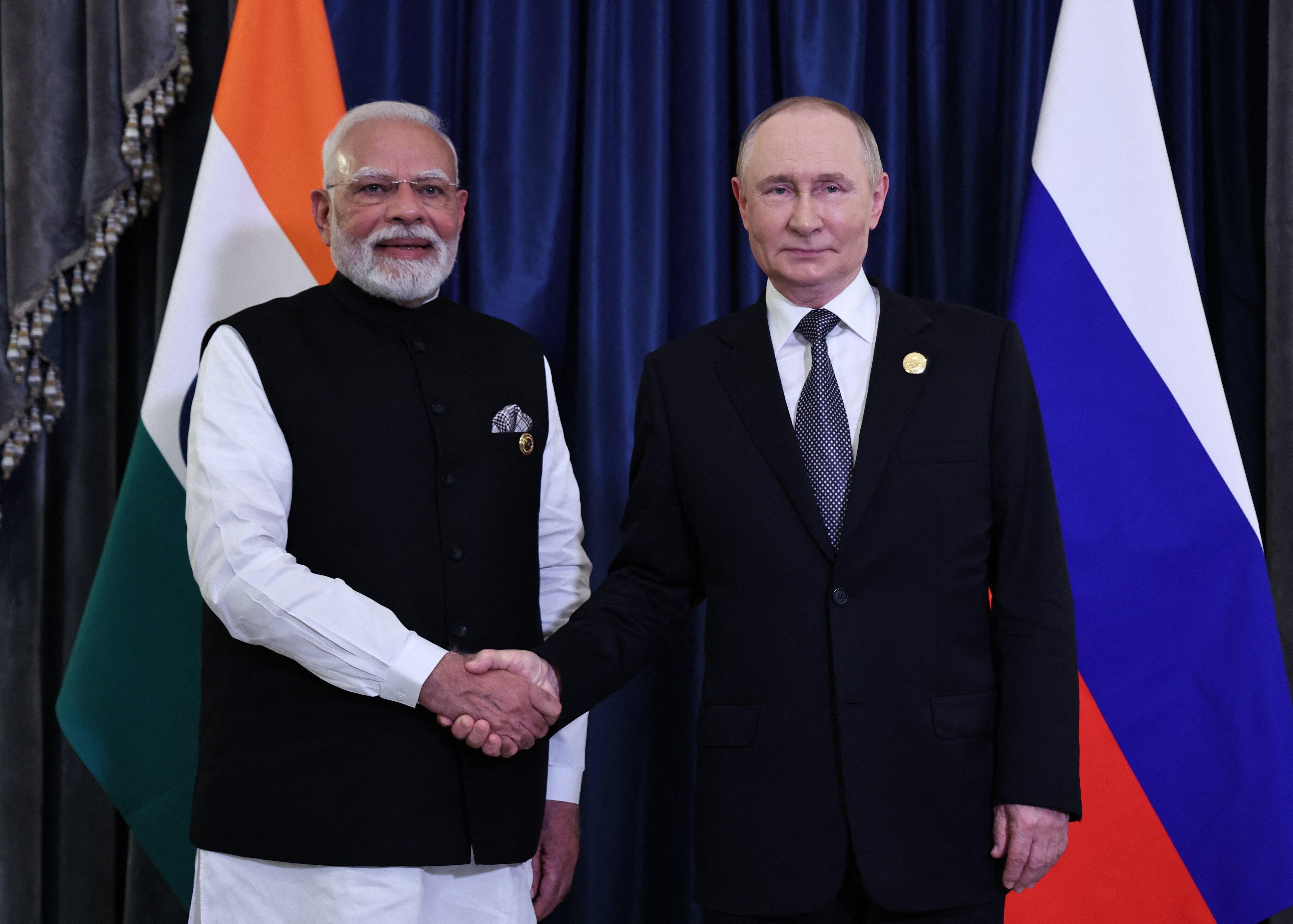 In this pool photograph distributed by the Russian state agency Sputnik, Russia's President Vladimir Putin and Indian Prime Minister Narendra Modi hold a meeting on the sidelines of the Shanghai Cooperation Organisation (SCO) Summit in Tianjin on September 1, 2025. (Photo by Alexander KAZAKOV / POOL / AFP via Getty Images)