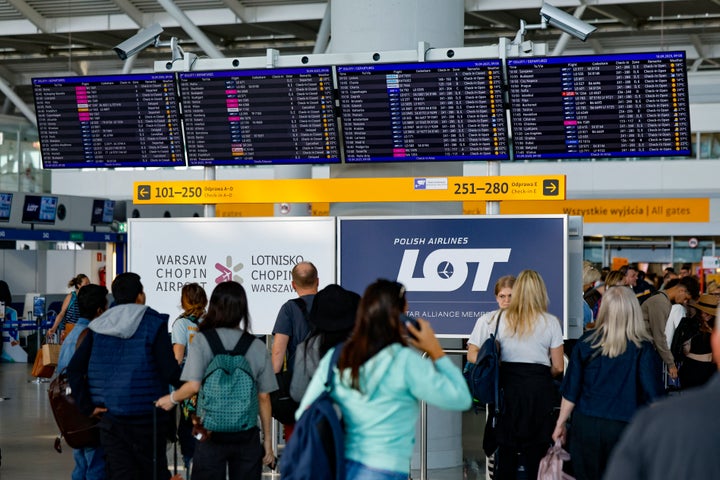 Passengers check their delayed flights on monitors at the international airport in Warsaw, on Sept. 10, 2025, after the airport was closed due to Russian drones violated Polish airspace on Wednesday morning. 