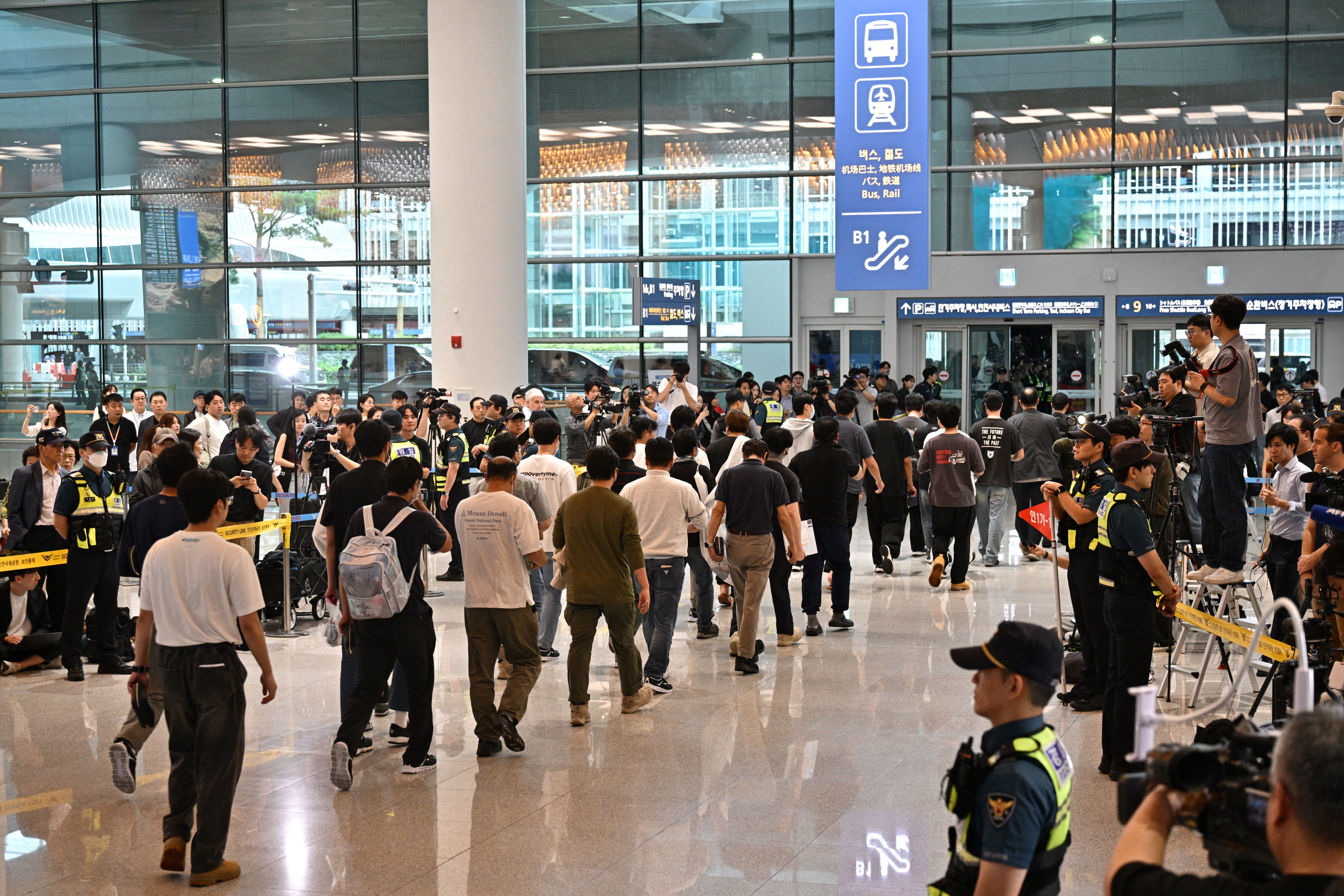 South Korean workers arrive at Incheon International Airport in Incheon on September 12, 2025, after the touch down of a specially chartered Korean Air Boeing 747-81 (KE9036) bringing hundreds of South Korean workers back from Atlanta after their detention in a US immigration raid at a Hyundai-LG plant in Ellabell, Georgia. (Photo by Anthony Wallace via Getty Images)