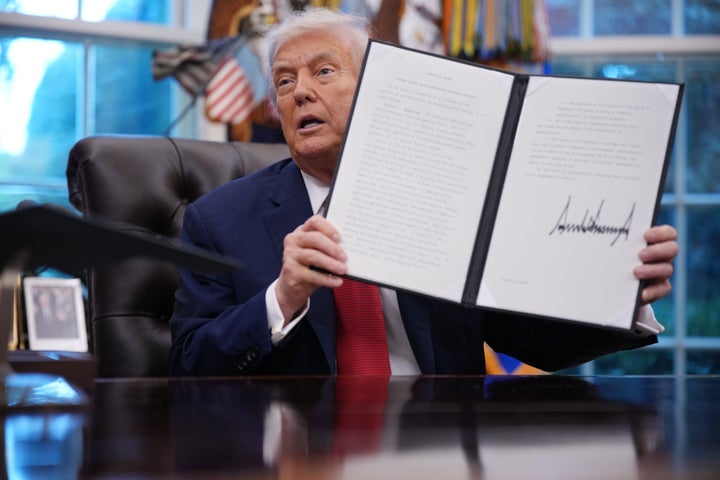 U.S. President Donald Trump displays a signed executive order in the Oval Office of the White House on September 25, 2025 in Washington, DC. Trump signed proclamations and an executive order, including approving a partial sale of TikTok’s U.S. operations, following a 2024 law requiring parent company ByteDance to divest or face a ban. (Photo by Andrew Harnik/Getty Images)