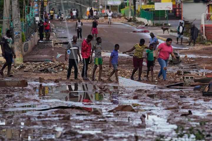 People walk through Santa Cruz, Jamaica, on Oct. 29, 2025, after Hurricane Melissa passed through.