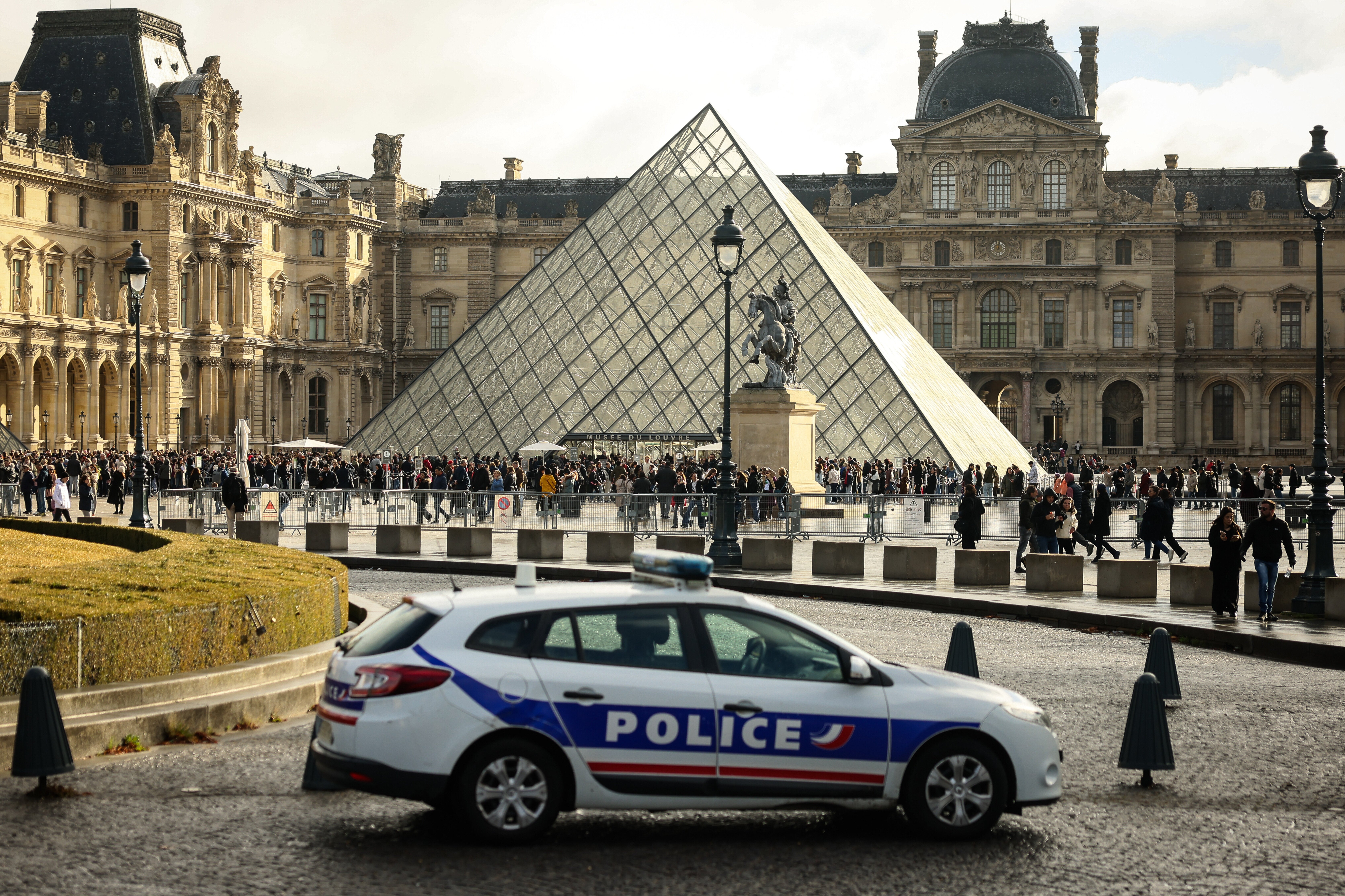 A police car parks in the courtyard of the Louvre museum, one week after the robbery, on Oct. 26, 2025, in Paris. (AP Photo/Thomas Padilla, File)