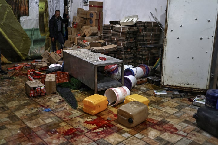 A man looks on near a pool of blood at the site of a reported shooting that left two Palestinians dead during a military operation in the occupied West Bank city of Jenin on November 27, 2025. The Israeli army and police said on November 27 they were reviewing an incident in Jenin in the occupied West Bank in which two Palestinians were filmed being shot after surrendering to Israeli forces (Photo by Zain JAAFAR / AFP via Getty Images)