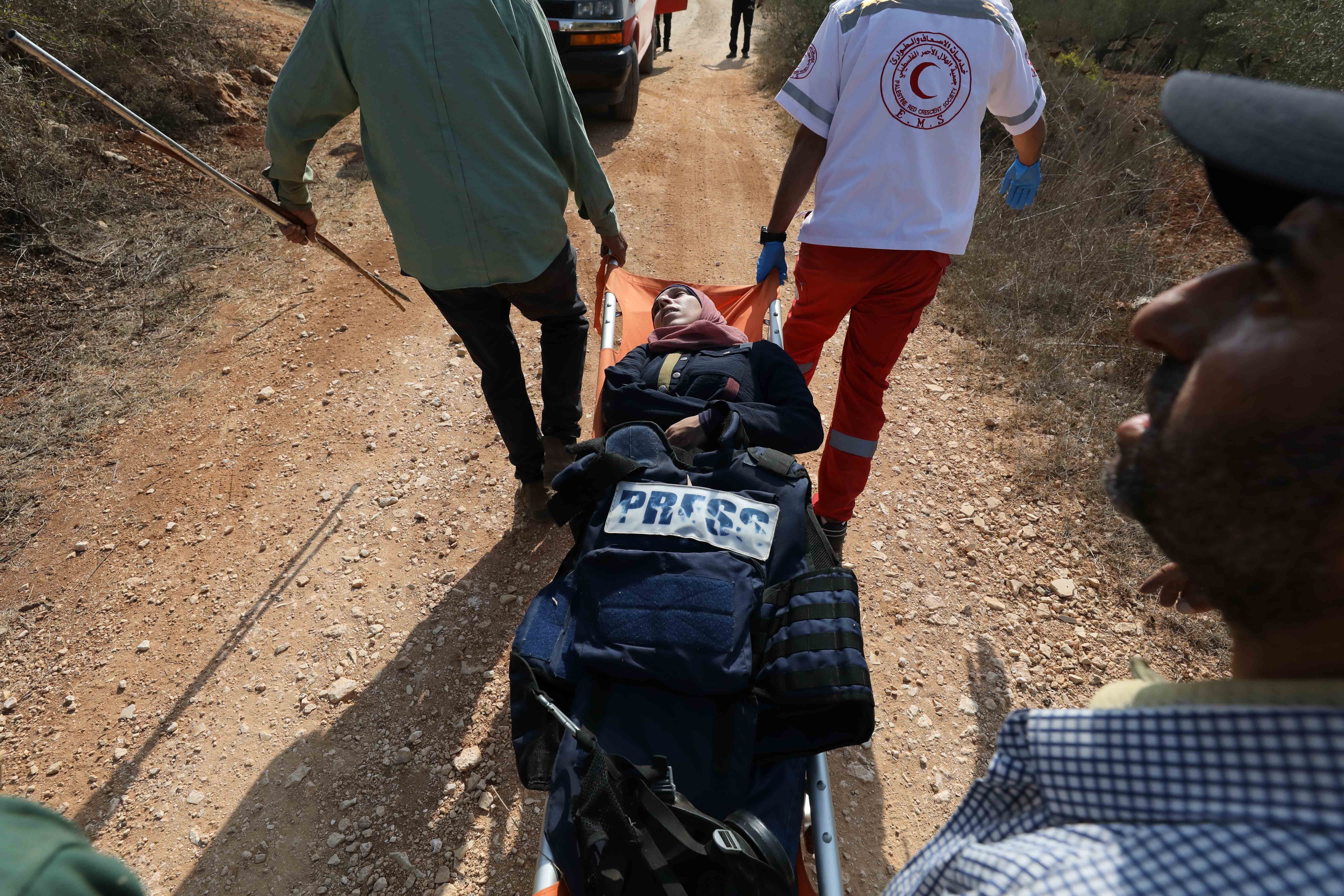 Paramedics carry Reuters reporter Raneen Sawafta, who was injured in an illegal settlers attack, on a stretcher in Beita town of Nablus, West Bank on November 08, 2025. (Photo by Nedal Eshtayah/Anadolu via Getty Images)