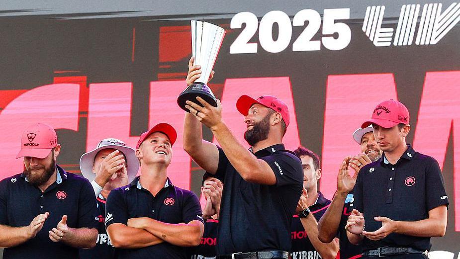 Jon Rahm holds up the 2025 LIV Golf team championship trophy beside his of Legion XIII team-mates