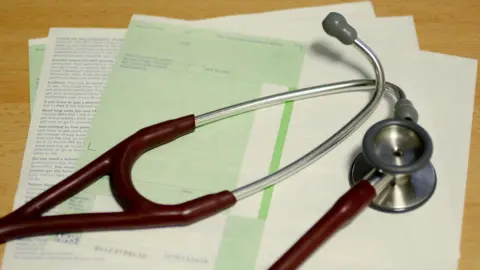 PA Media A stethoscope on top of scattered medicine prescription papers