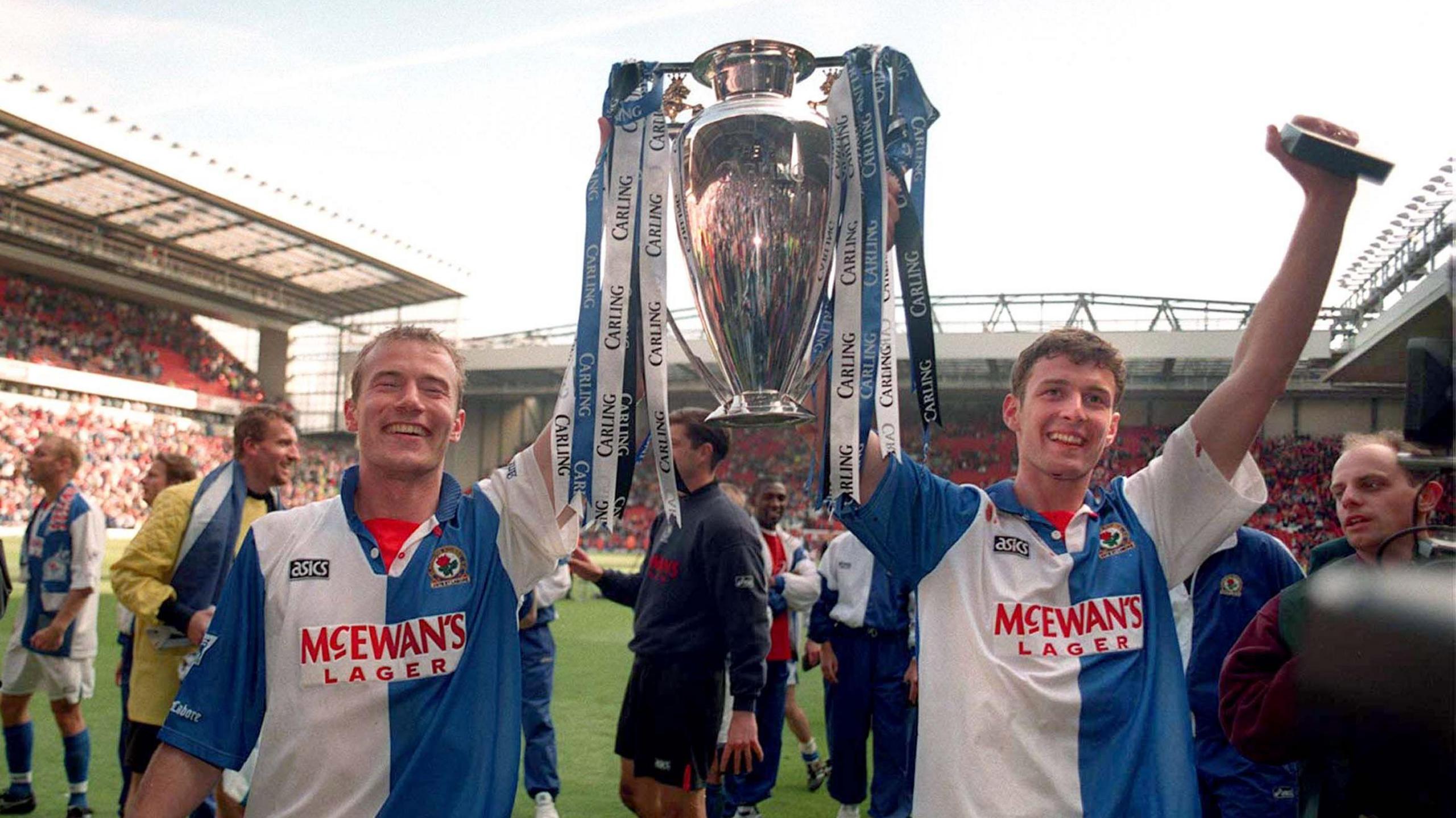Blackburn Rovers strike partners Alan Shearer (left) and Chris Sutton celebrate with the Premier League trophy after being crowned champions in 1994-95