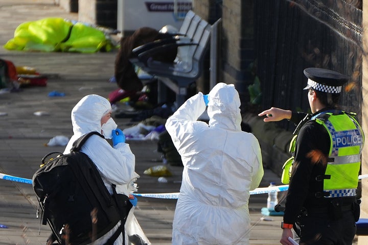 Forensic investigators look at the area where travellers left their belongings after a mass stabbing on a London-bound train in Huntingdon, England, on Nov. 2, 2025.