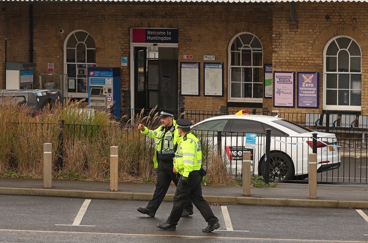Police officers walk outside Huntingdon Station in Huntingdon, eastern England, on Nov. 3, 2025, where an LNER Azuma train was diverted to on Saturday.