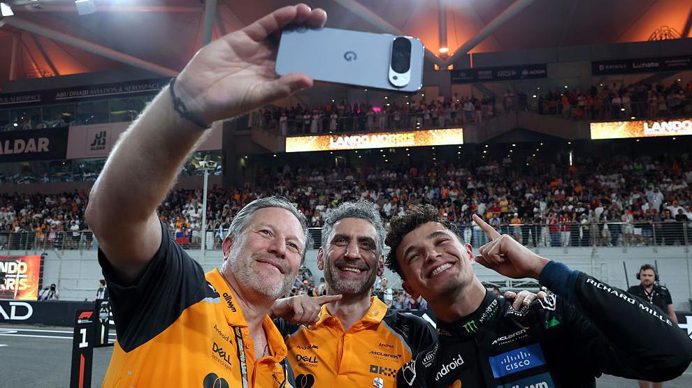 McLaren Racing CEO Zak Brown, team principal Andrea Stella and Lando Norris pose for a selfie after the Abu Dhabi Grand Prix