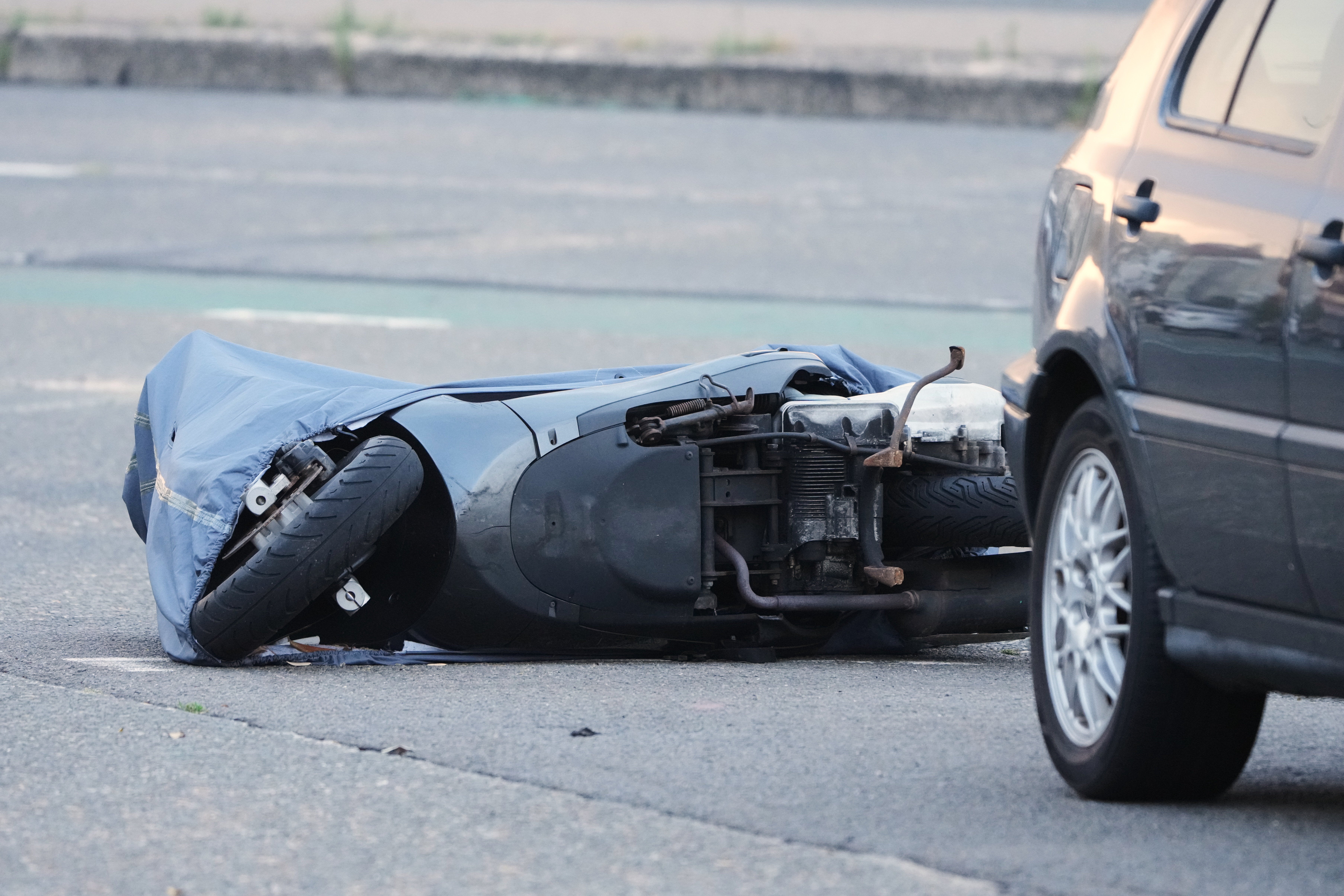 A motorcycle lies on the ground in the early morning near the site of a shooting Sunday at Sydney's Bondi Beach, Monday, Dec. 15, 2025. (AP Photo/Mark Baker)