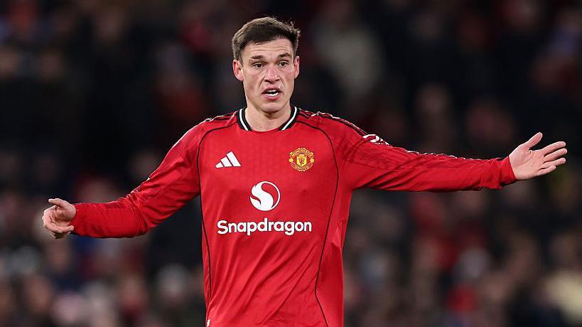 Manuel Ugarte gestures to his Manchester United team-mates