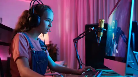 Getty Images Concentrated teenage girl gaming