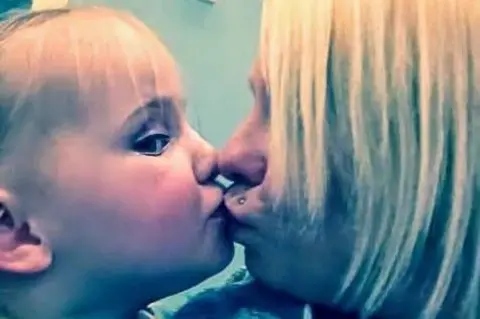 Sonia Hopkin A picture of a young Tiegan kissing her mother Sonia
