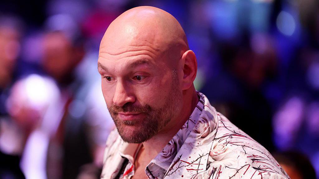 Tyson Fury wearing a white shirt with roses
