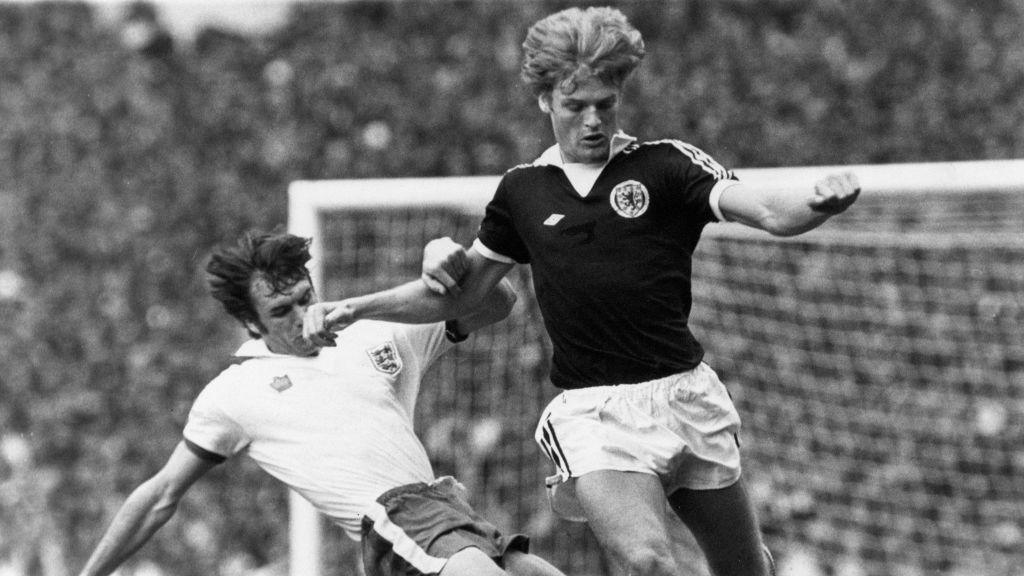 Gordon McQueen of Scotland battles for the ball during a match against England in 1977