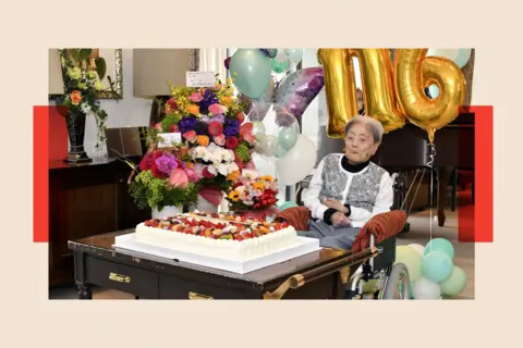 Shutterstock A woman sitting with a birthday cake