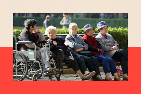 Getty Images A group of elderly women sit on a bench in Fuxing Park in Shanghai