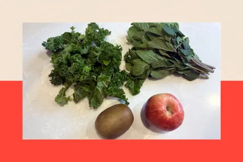 A image by Hugh Pym and a kiwi, apple, kale and mint leaves