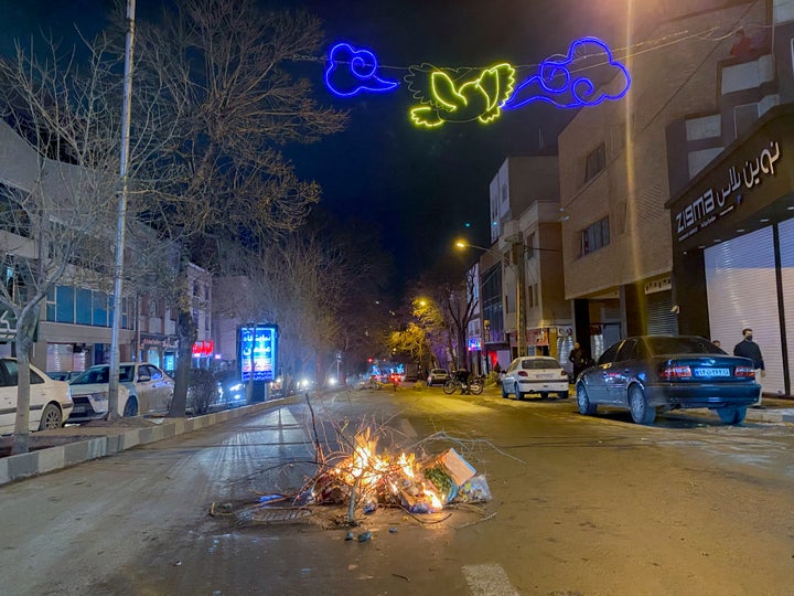Burning debris lies in the middle of a street during unrest in Hamedan, Iran on January 1, 2026. (Photo by Mobina / Middle East Images / AFP via Getty Images)