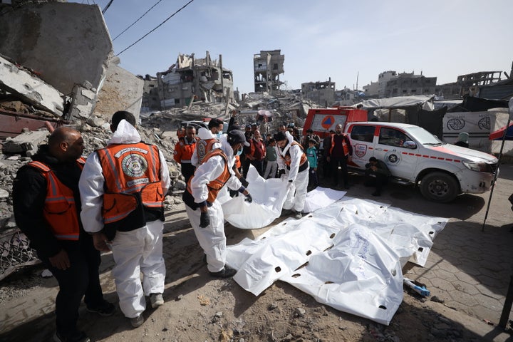Civil defense and forensic teams exhume the bodies of dozens of Palestinians killed in Israeli attacks, from a temporary burial site at the Selahaddin Mosque in Zeitoun for transfer to official cemeteries in Gaza City, on Jan. 25, 2026.