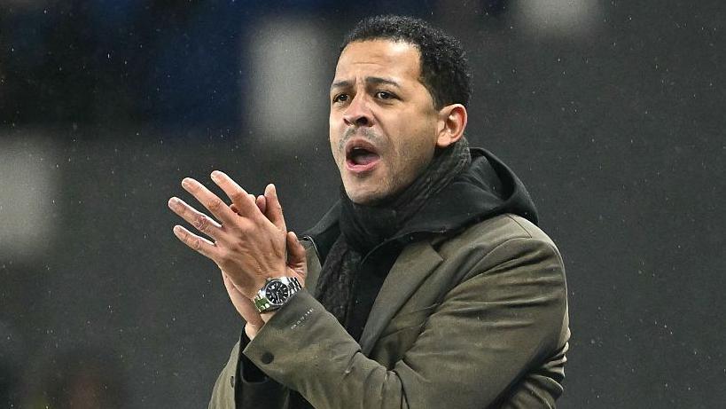 Strasbourg manager Liam Rosenior clapping in the dugout