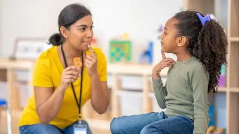 Getty Images Speech and language therapist with child