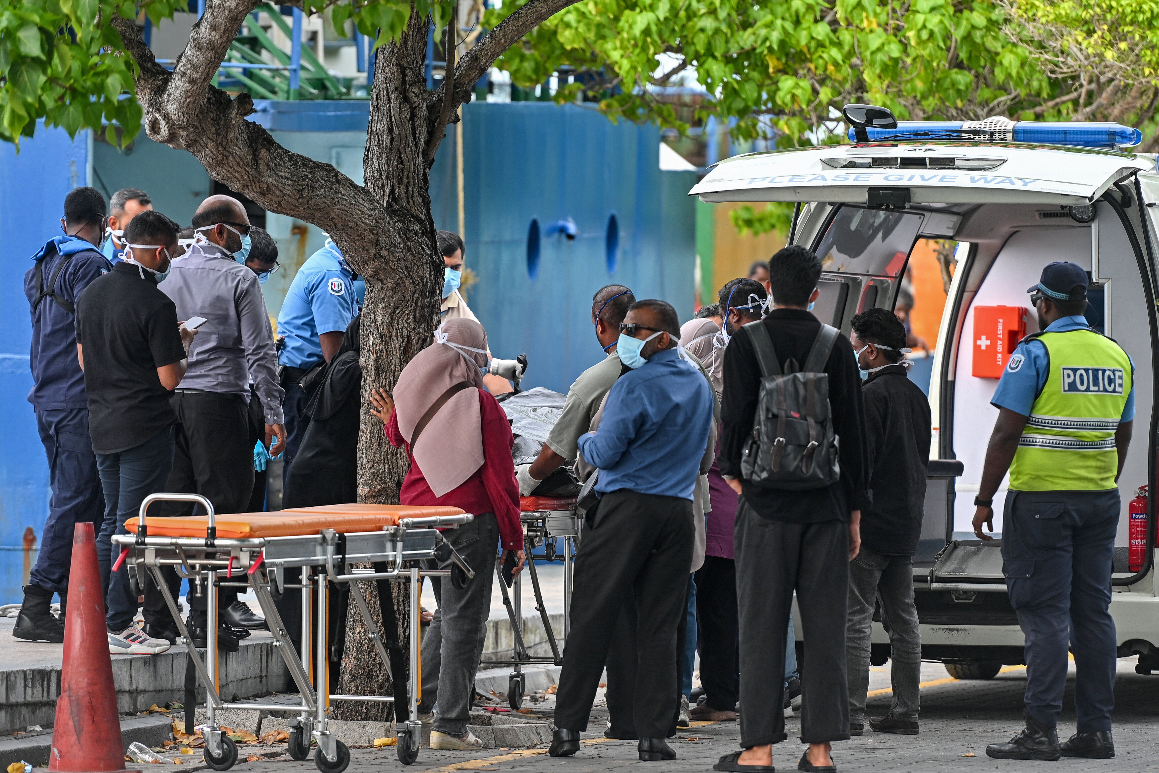 Red Crescent emergency responders and police personnel transfer the bodies of Italian tourists from a police speed boat to an ambulance in Male on Tuesday.