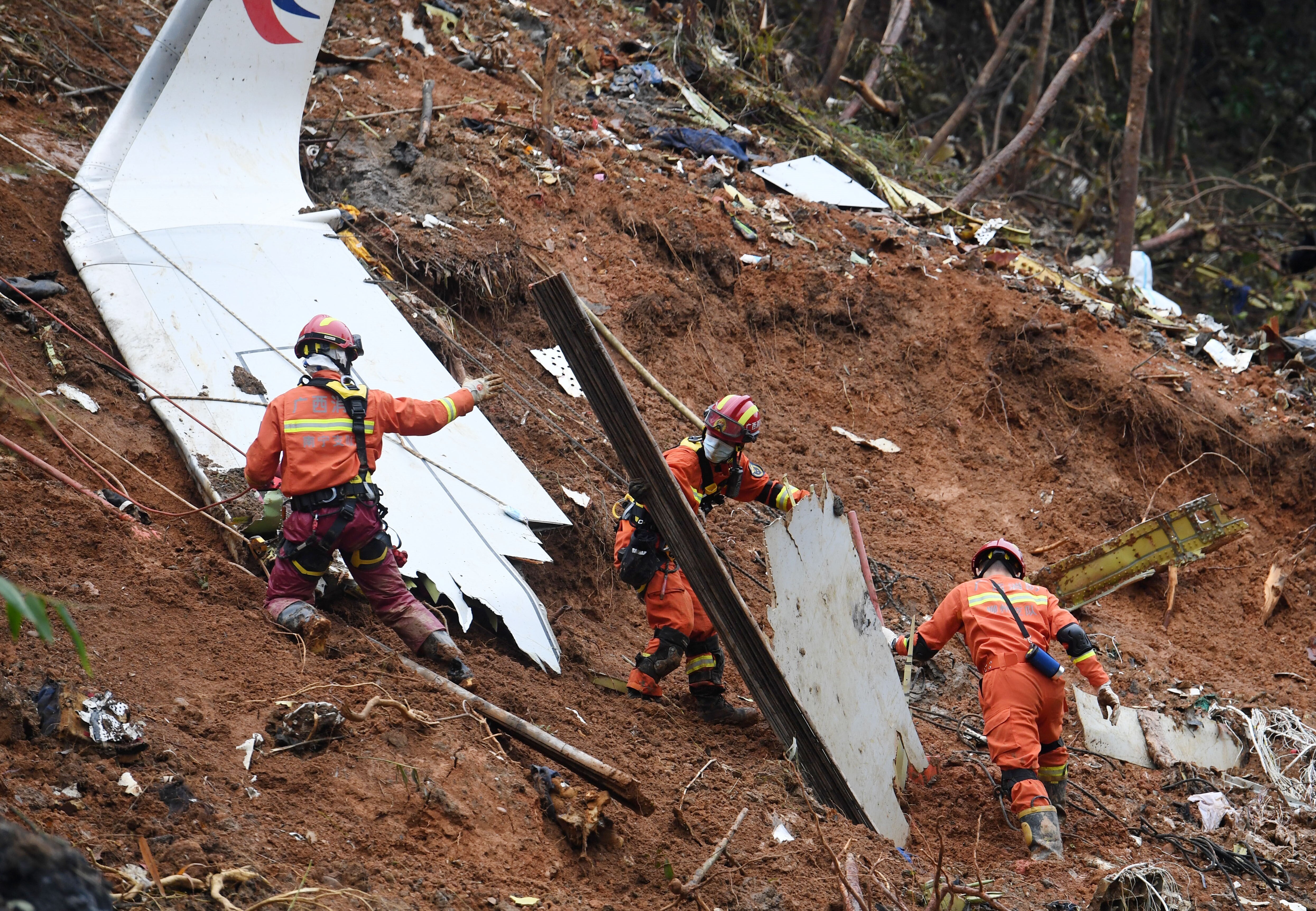 Rescuers conduct search and rescue work at a plane crash site in Tengxian County, south China's Guangxi Zhuang Autonomous Region, March 24, 2022. (Photo by Lu Boan/Xinhua via Getty Images)