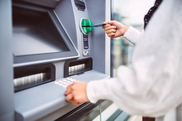 Close-up of hand inserting debit card into automated an ATM machine. Cash withdrawing, paying bills, checking account balance, t
