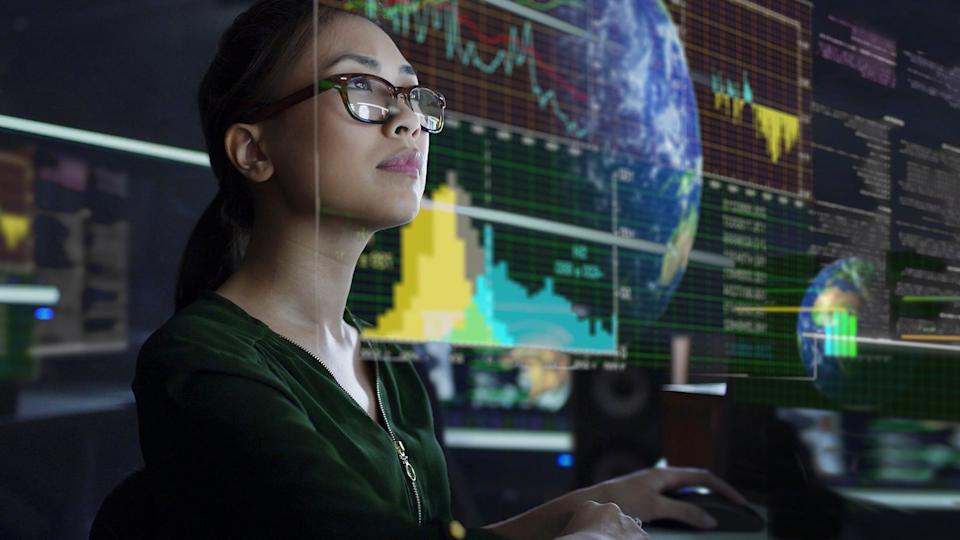 An investor looks at an information dashboard.