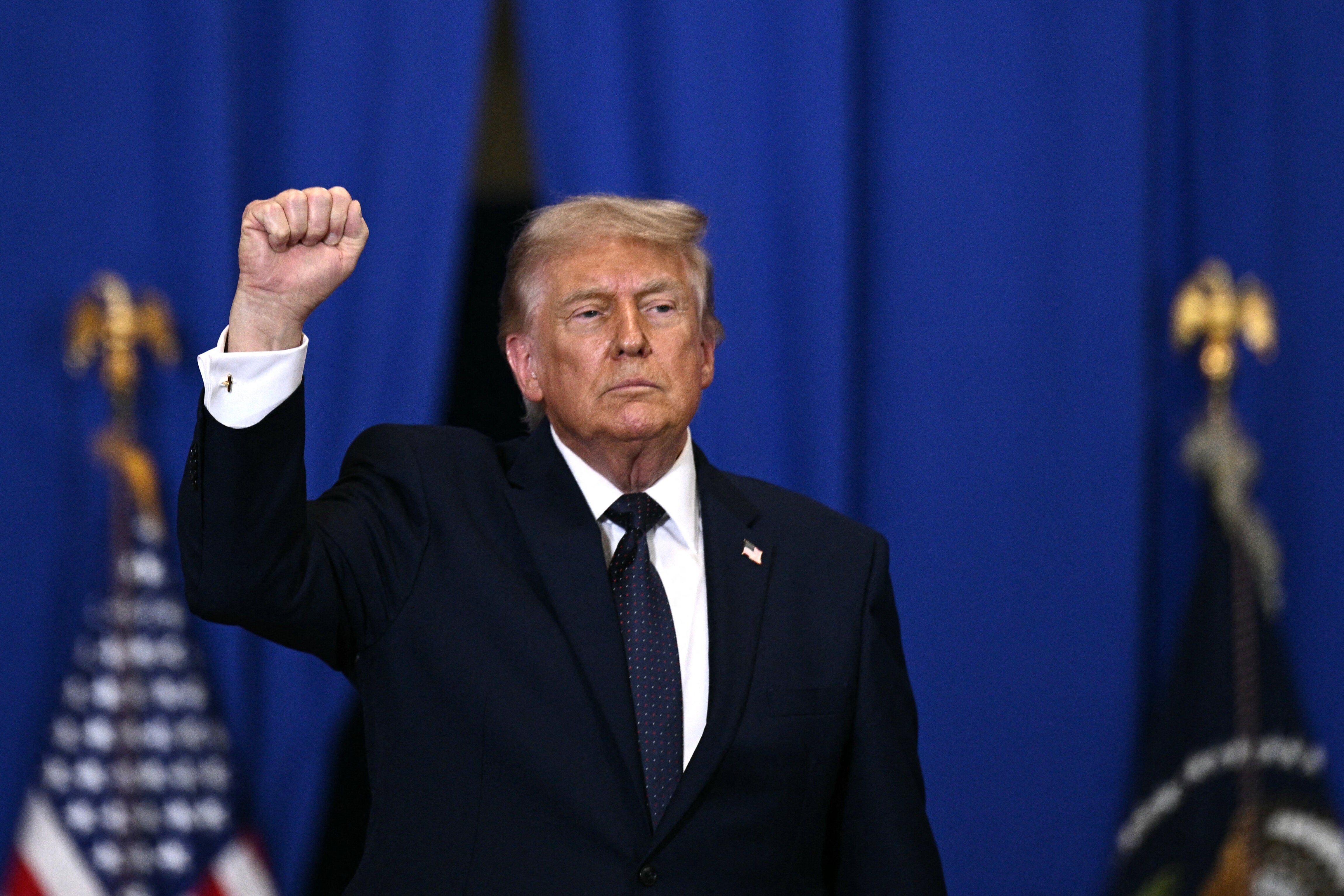 US President Donald Trump raises a fist as he departs after delivering a speech about the economy at Rockland Community College Fieldhouse in Suffern, New York, on May 22, 2026. Trump is the first sitting president to visit the northern New York City suburbs since Gerald Ford in 1976. (Photo by Brendan SMIALOWSKI / AFP via Getty Images)