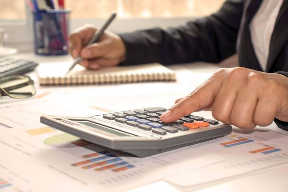 doing bills or taxes, calculator in foreground