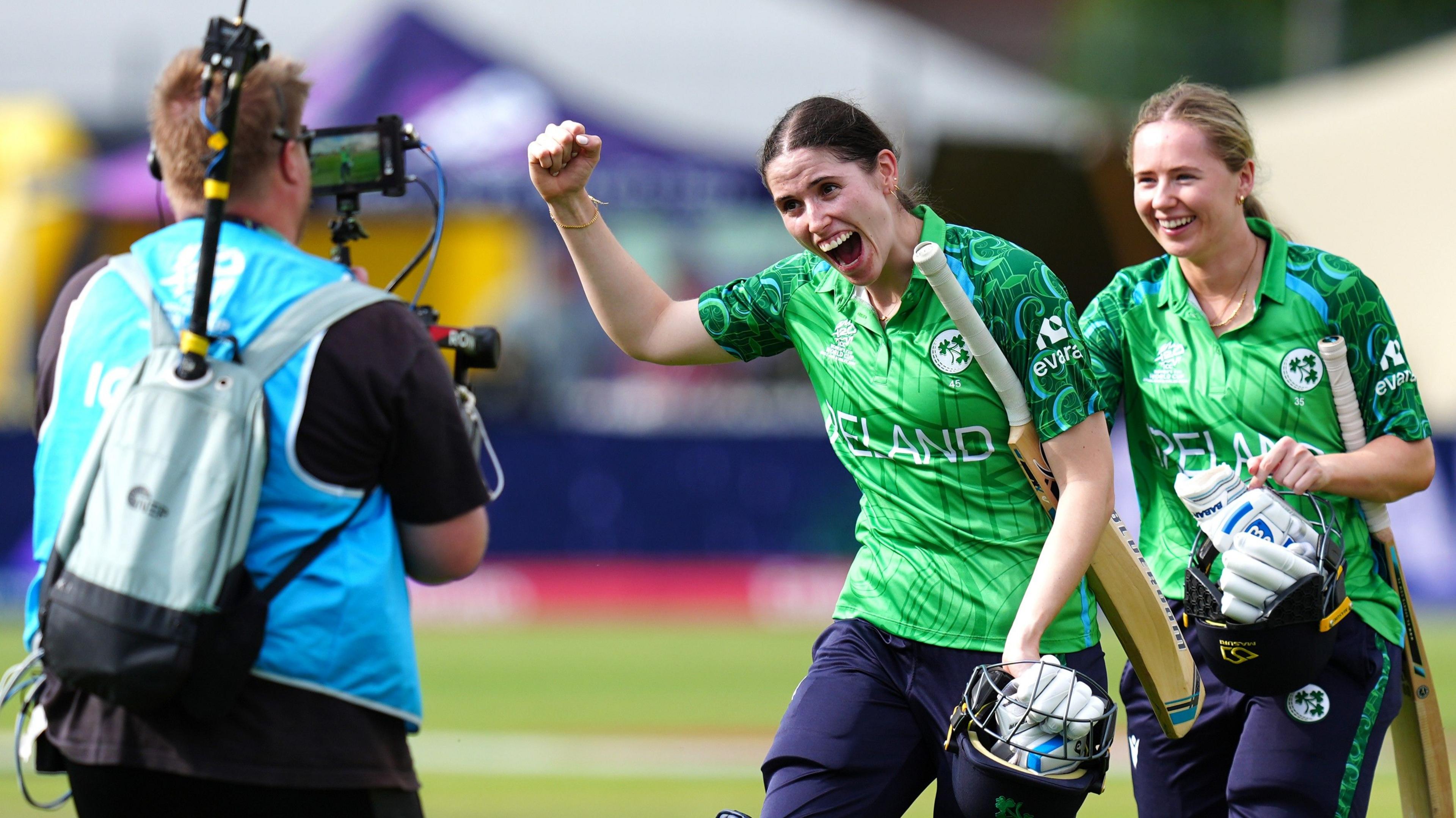 Ireland batters walk off after winning and celebrate in front of the camera