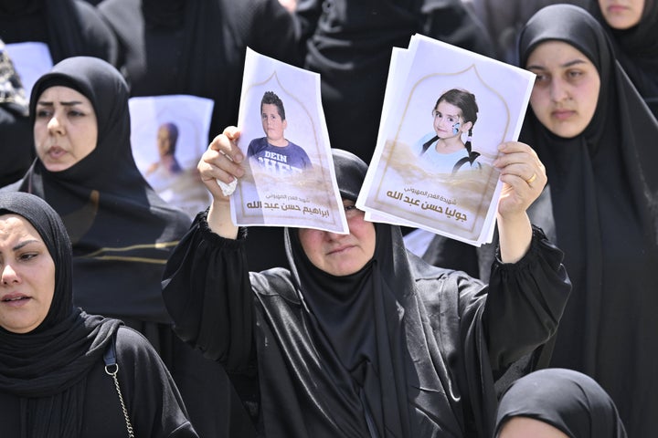 People attend a funeral ceremony held for a family of six, consisting of a father, mother and four children, who lost their lives in an Israeli strike on the town of Al-Mariwaniyeh in southern Lebanon on Wednesday.
