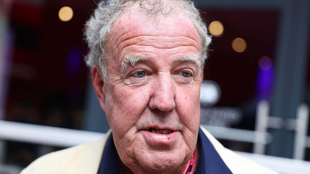 A closeup of TV presenter Jeremy Clarkson with grey hair and eyebrows looking to the right.